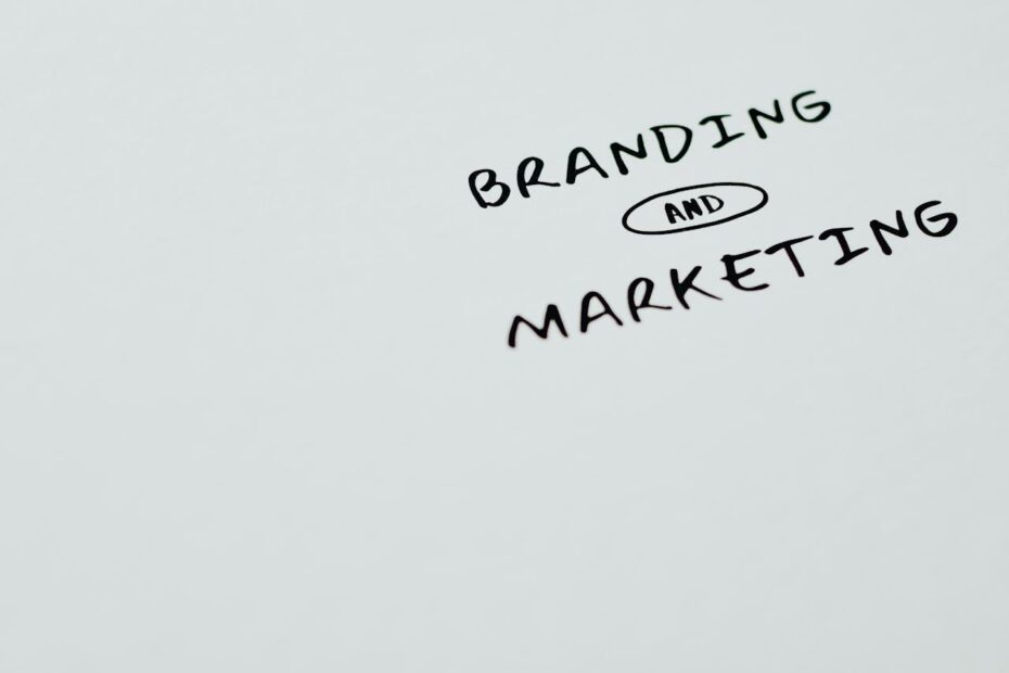 Handwritten text reading "Branding and Marketing" on a white surface, with "and" circled in an oval.